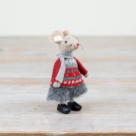 Stuffed mouse toy wearing a red sweater with a pattern on a wooden surface