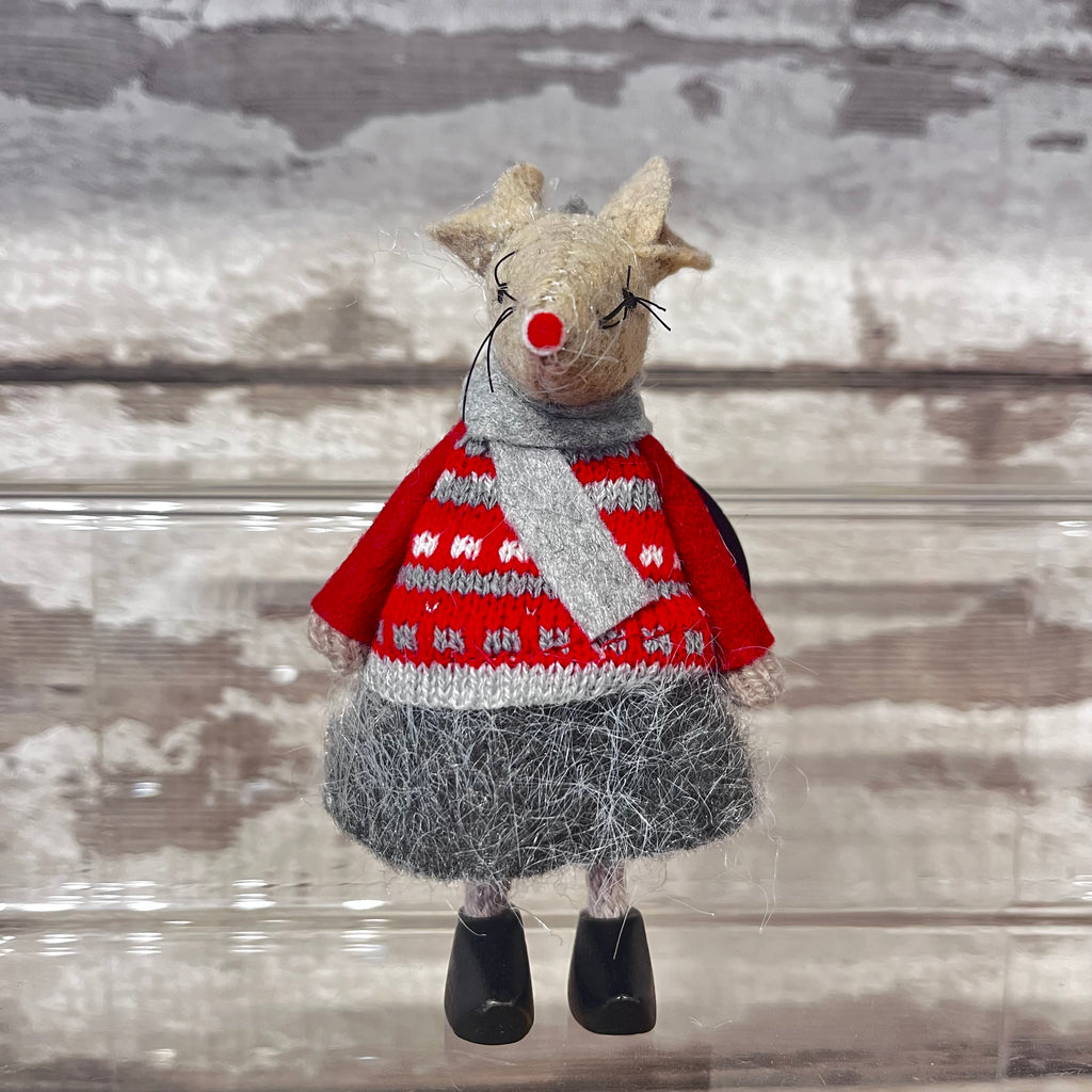 Fabric mouse decoration in red knitted sweater with scarf and clogs on a wooden background 