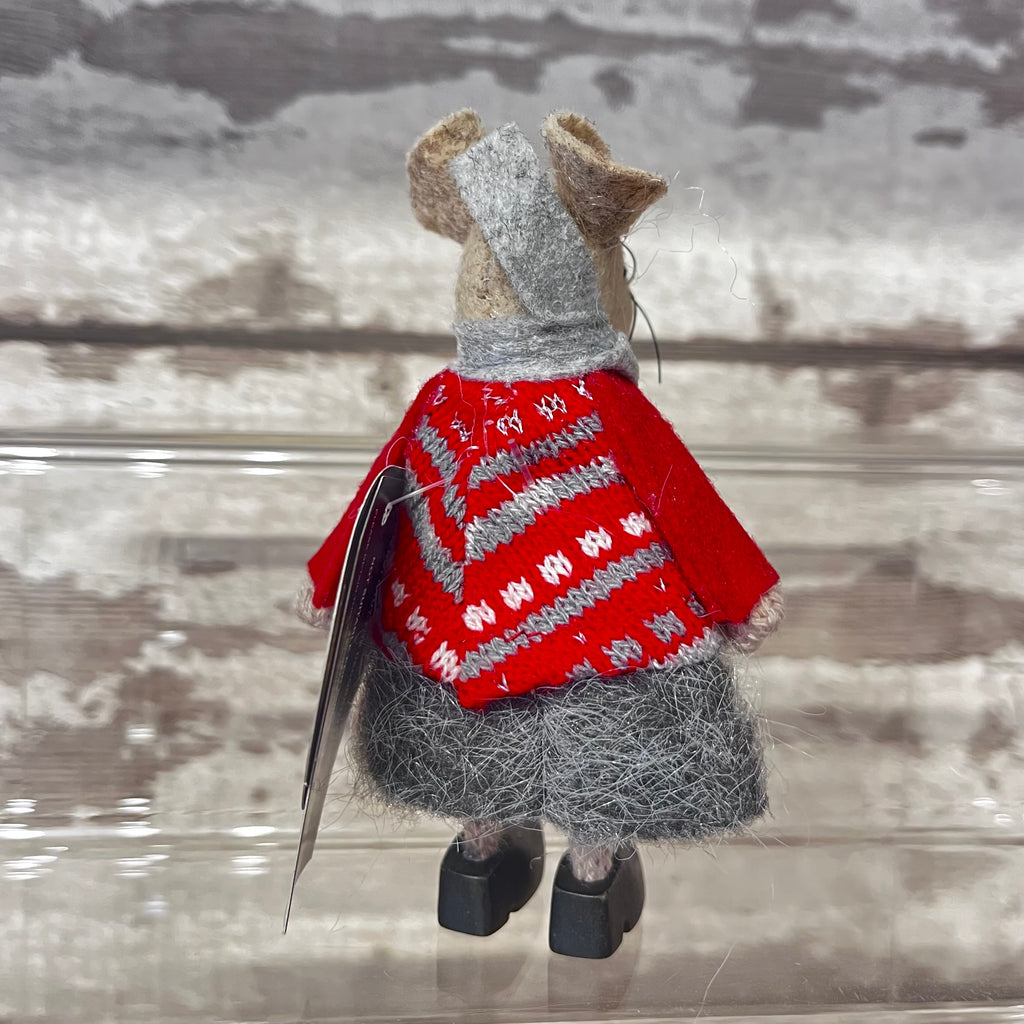 Back side of fabric mouse decoration in red knitted sweater with scarf and clogs on a wooden background 