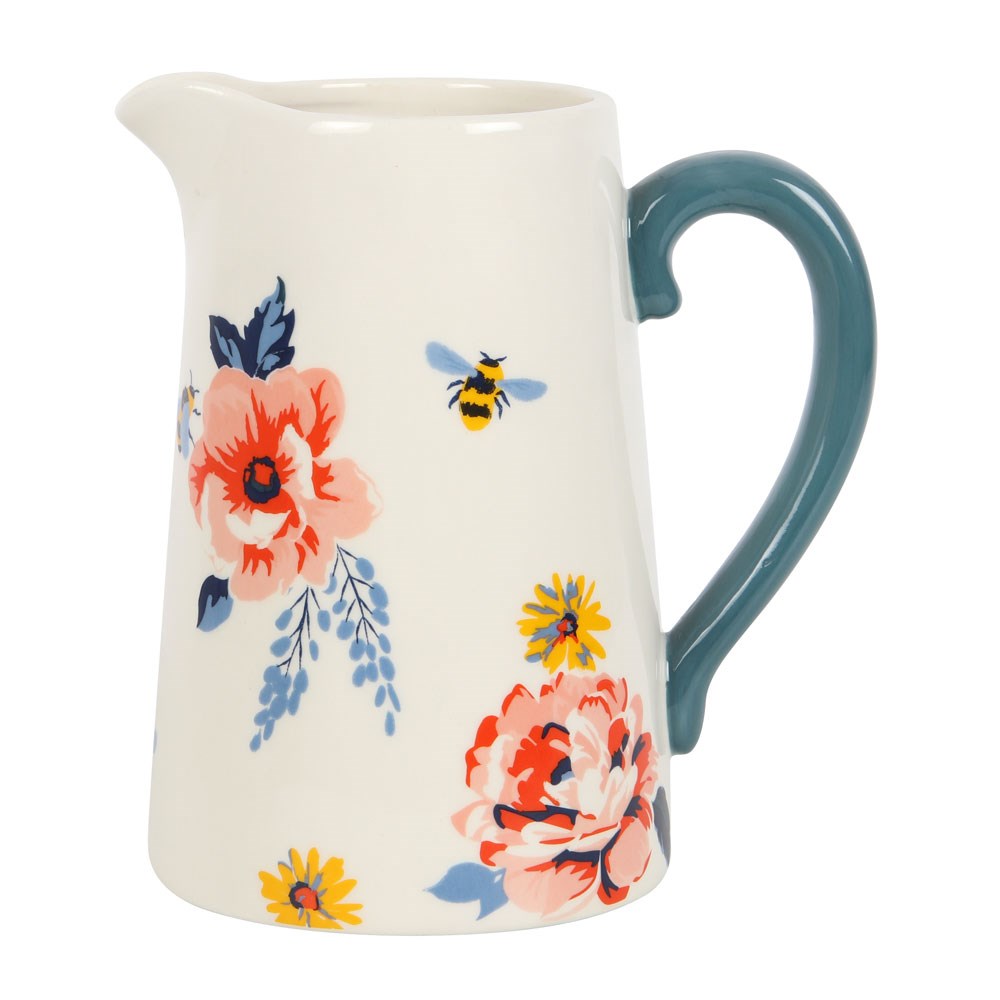 Jug/pitcher shaped cermaic flower vase with teal coloured handle. Jug features a floral design with bees on a white background.