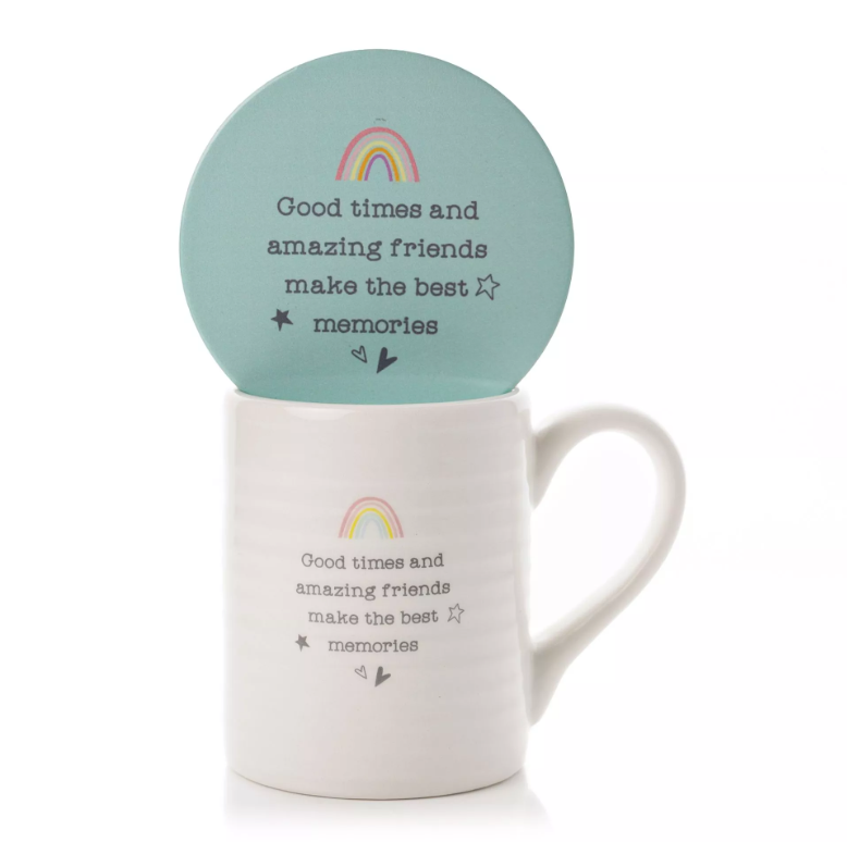White, horizontally ribbed mug with blue interior and quote 'Good times and amazing friends make the best memories' printed on the front in a typewriter front. Above the quote is a small rainbow illustration. Below the quote is two little hearts. Features a blue circle coaster with same design on. 
