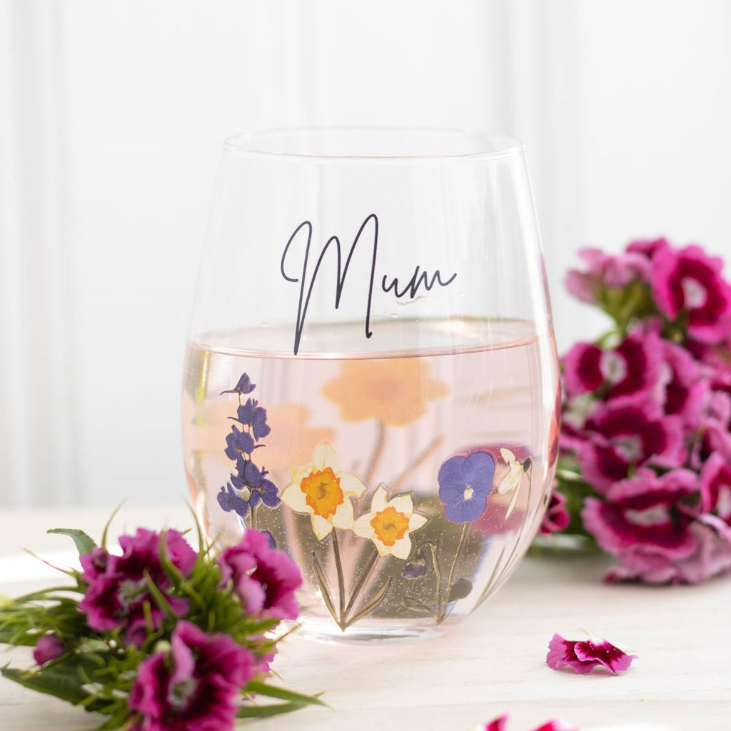 Stemless wine glass with a floral design on the bottom and 'Mum' written in script front