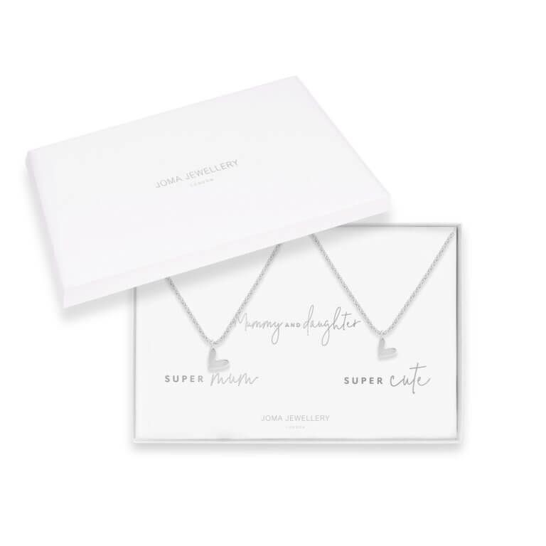 White box with two silver necklaces with silver heart charms inside. Inside the box 'mummy and daughter' is printed in silver between the two necklaces. Underneath the necklace on the right the text 'super mum' is printed in silver, and under the left necklace 'super cute' is printed in silver. 