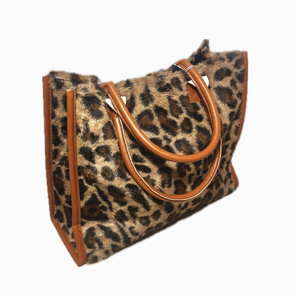 furry leopard print bag with brown leather handles and accents.